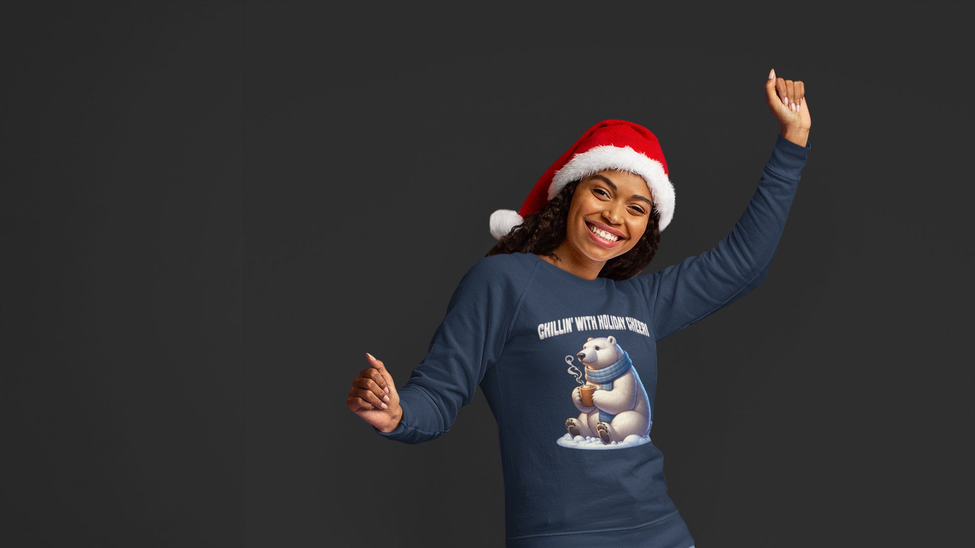 Happy woman in Santa hat wearing navy blue Chillin’ With Holiday Cheer sweatshirt featuring a polar bear with mug, cozy adult holiday fashion by CarolArtWorks.